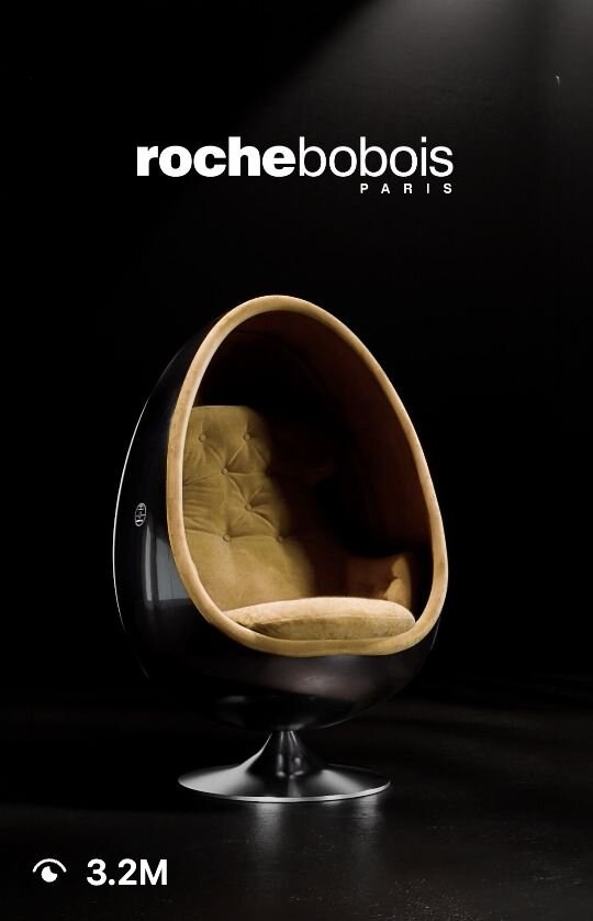Fauteuil Ovalia Roche Bobois éclairé sur un fond sombre.
